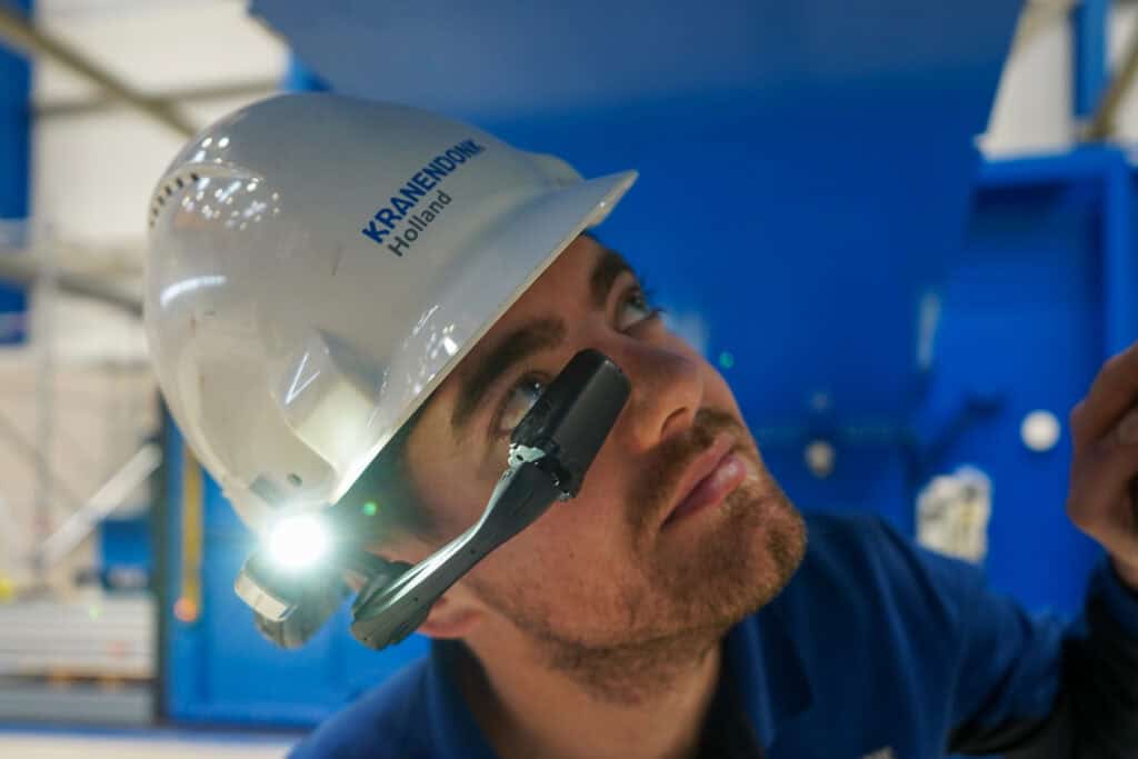 KRANENDONK operator wearing a smart headset with camera and light to share visual context during remote support.